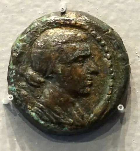 Portrait of Cleopatra VII on an ancient bronze coin from Alexandria.