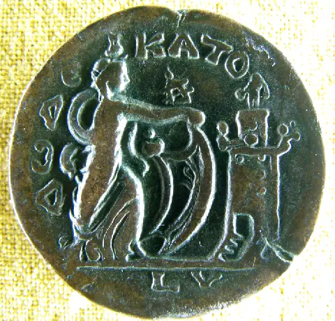 Ancient Alexandrian bronze coin showing the Pharos lighthouse and Isis Pharia holding a sail.