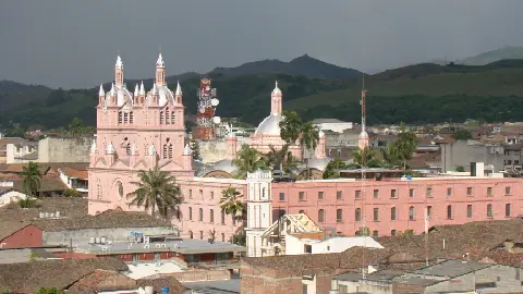 Panoramic photograph of Guadalajara de Buga in Colombia, with the Basilica of the Lord of Miracles above the city rooftops.