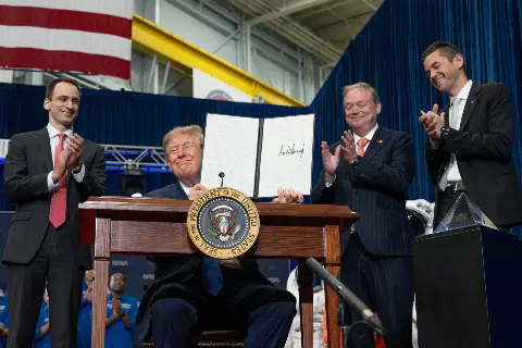 President Trump holding the signed United States Space Academy executive order